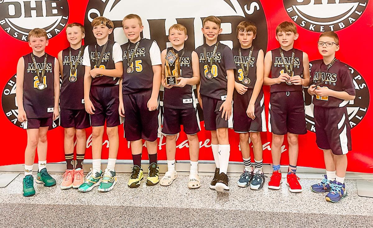 Members of Mars Boys Youth Basketball Associations’ Fourth Grade Boys Blue Travel Basketball Team, (from left) Tyler Pyle, Grayson Panzer, Kobe Webster, Jack Baumgartel, Brett Ando, Tyler McKinney, Andrew Lohr, Alex Palasick and Evan Muehlfeld, gather for a picture after taking first place in the OHB Ohio Valley Classic.